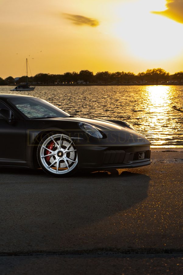 Nose-on view of the GT3, headlights toward the bay at sunset