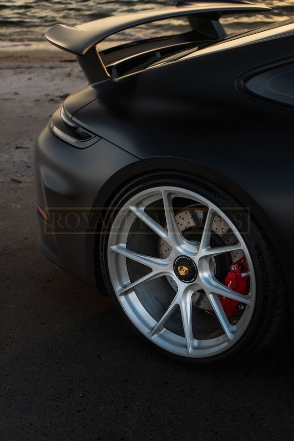 Close-up from above of the GT3 rear wheel, red brake caliper and rear wing