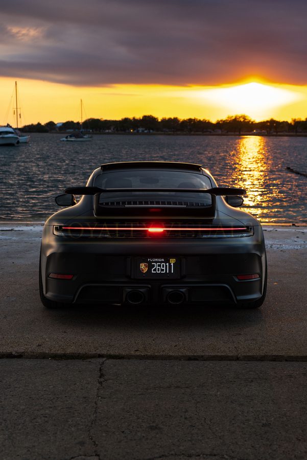 Straight-on rear view of the GT3 with light bar and diffuser, sunset behind