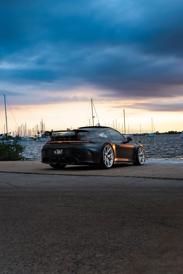 Wide rear three-quarter of the GT3 with the Davis Islands marina