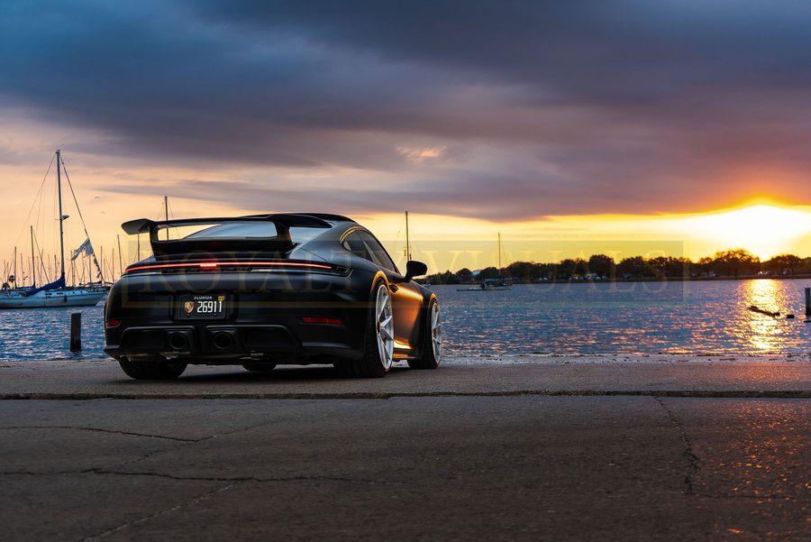 Wide rear three-quarter of the GT3, marina behind