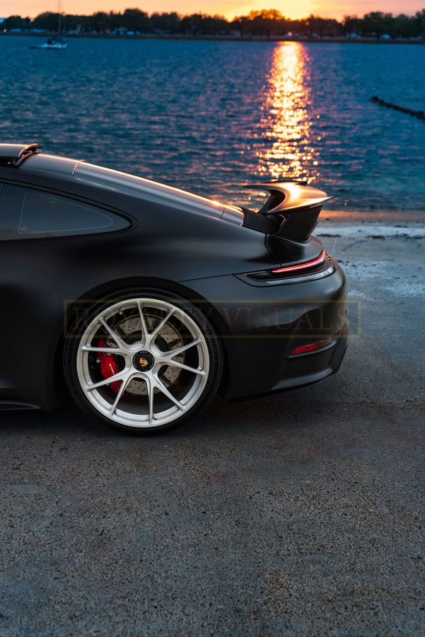 Rear wheel and wing detail of the GT3 with the bay behind
