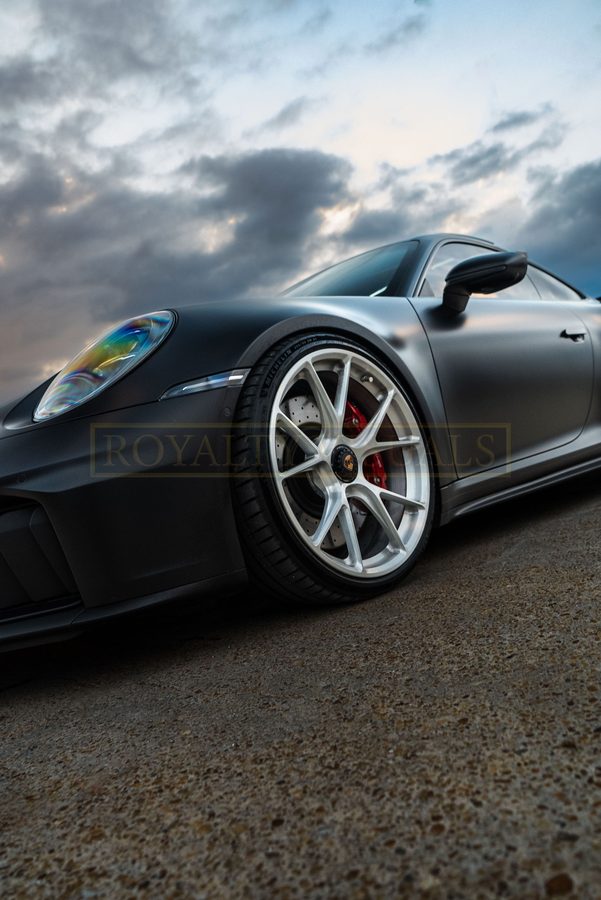 Front detail of the GT3 headlight and wheel against a moody sky