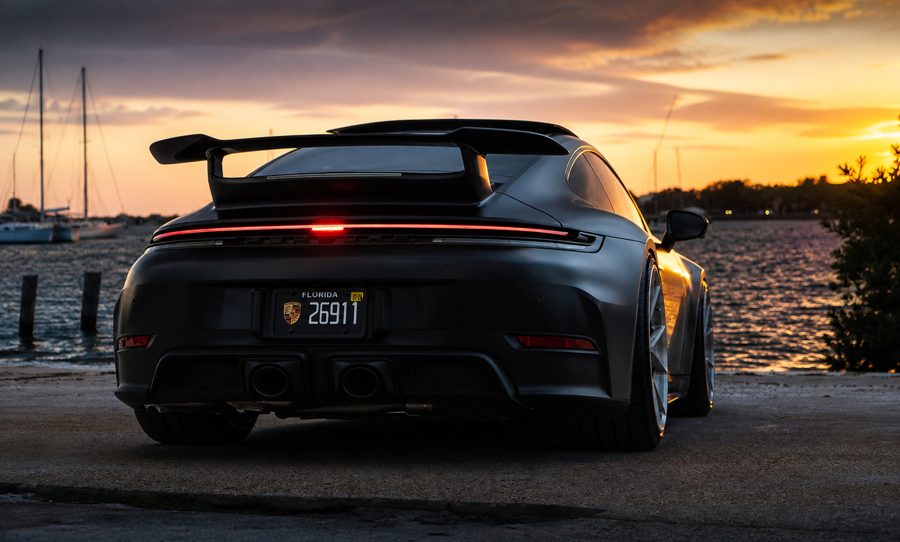 Rear view of Pri’s satin-black 992 GT3 at sunset over Hillsborough Bay, plate 26911